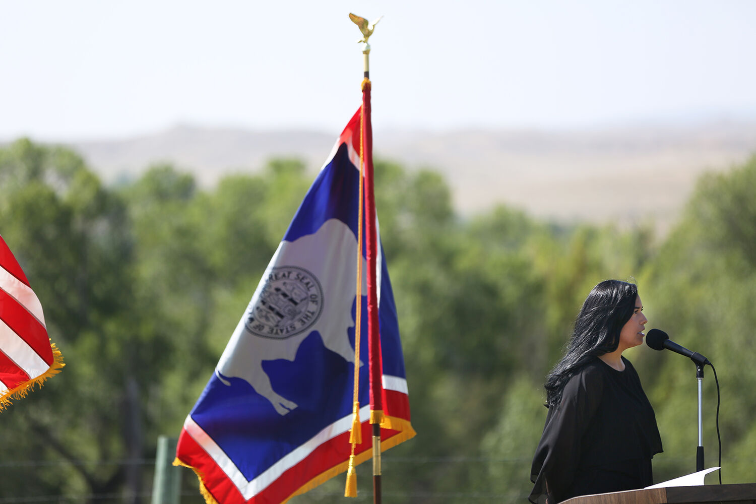 Spc. Bec Bridger sings the national anthem to begin the groundbreaking ceremony
